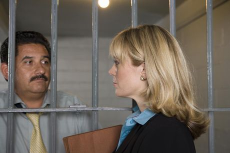man inside the jail talking to his attorney