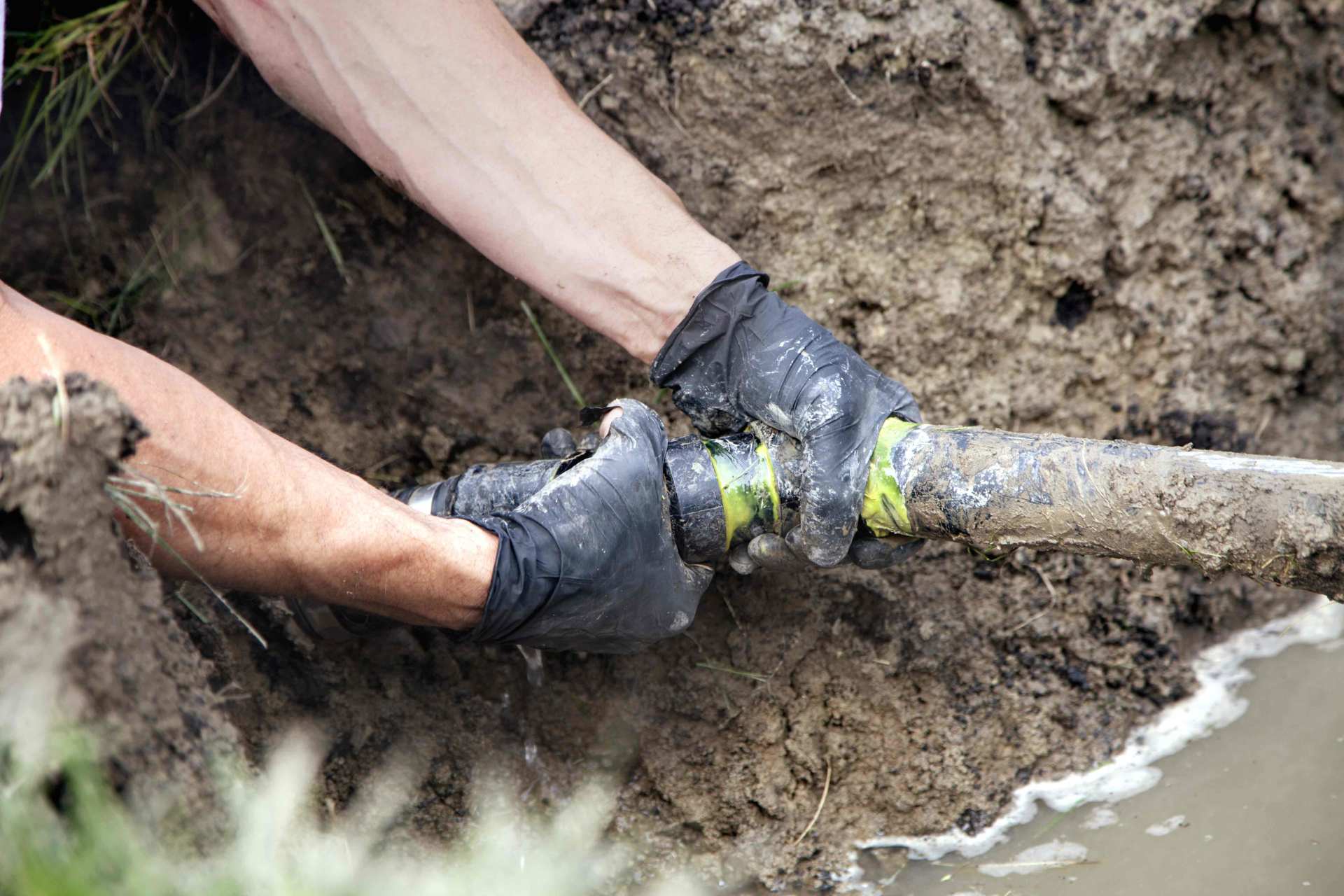 Septic Repair Montville CT — Man Repairing the Pipe in Southeastern CT Septic Repair Montville CT — Man Repairing the Pipe in Southeastern CT