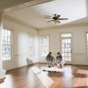 two people in empty room of house