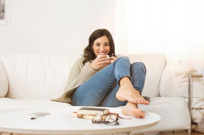 Residential HVAC Service — Woman Sitting While Drinking a Cup Coffee in South Lyon, MI Residential HVAC Service — Woman Sitting While Drinking a Cup Coffee in South Lyon, MI