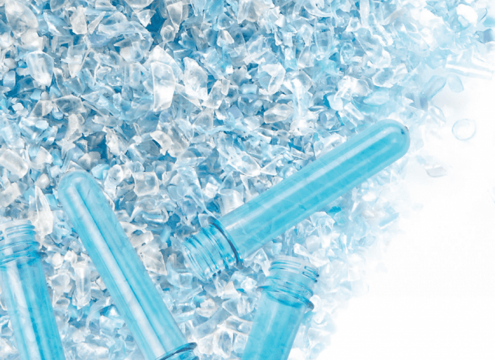 A pile of blue plastic bottles sitting on top of a pile of ice.