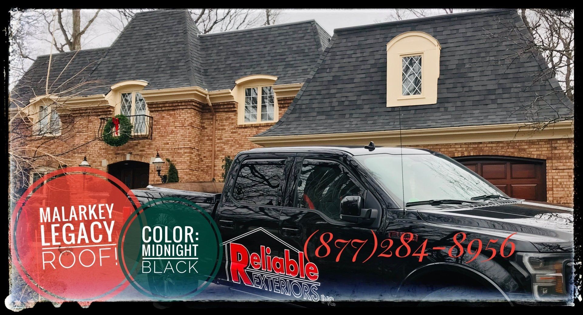 A black truck is parked in front of a large brick house.