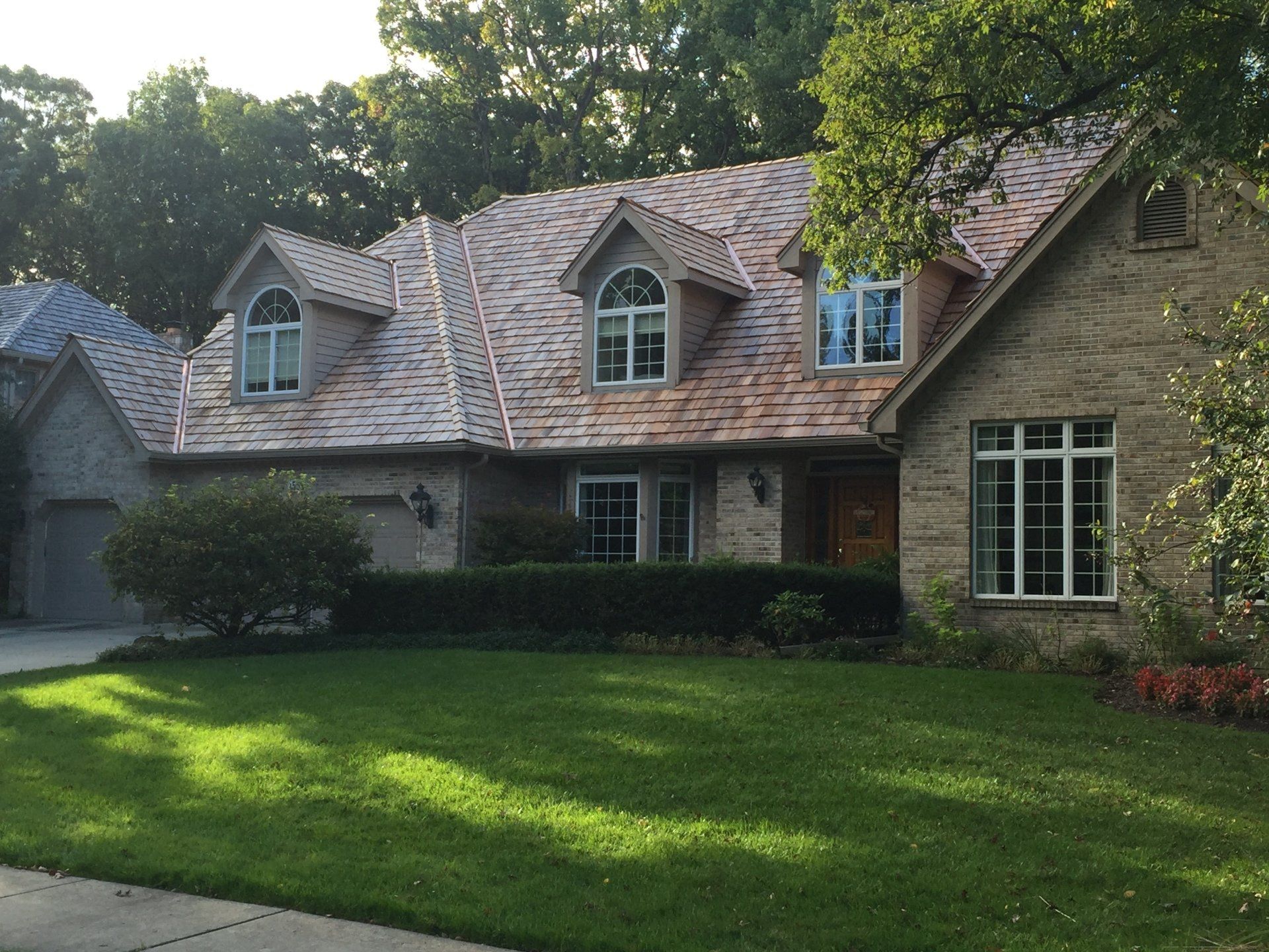 A large house with a lush green lawn in front of it