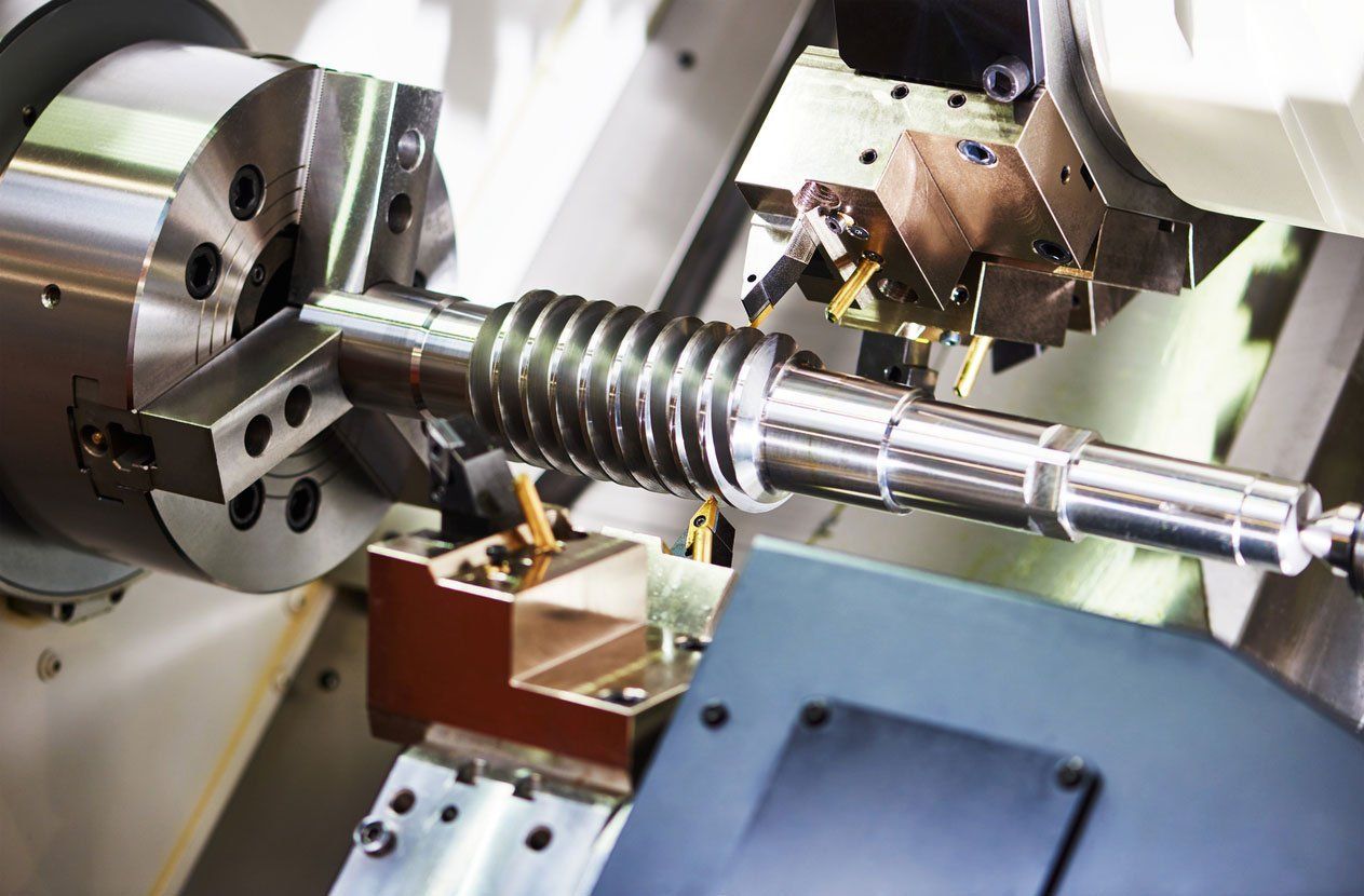 A machine is cutting a metal object on a lathe.