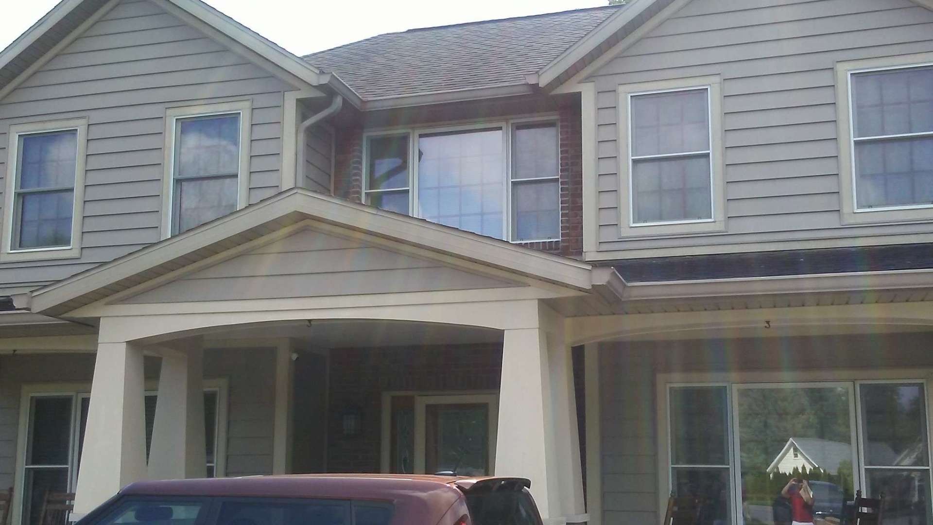 A house with a car parked in front of it