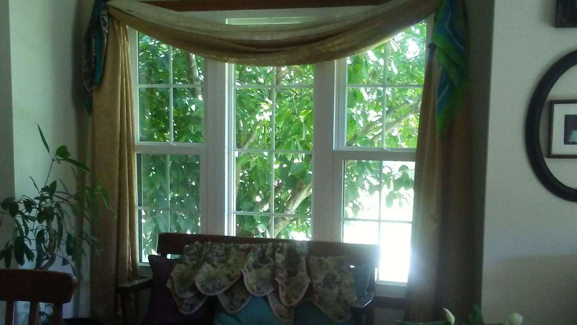 A living room with a large window and a chair