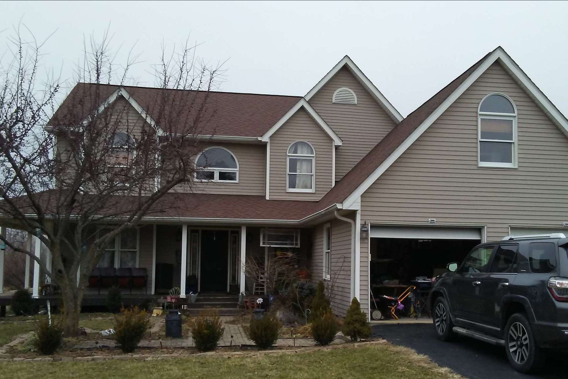 A large house with a car parked in front of it