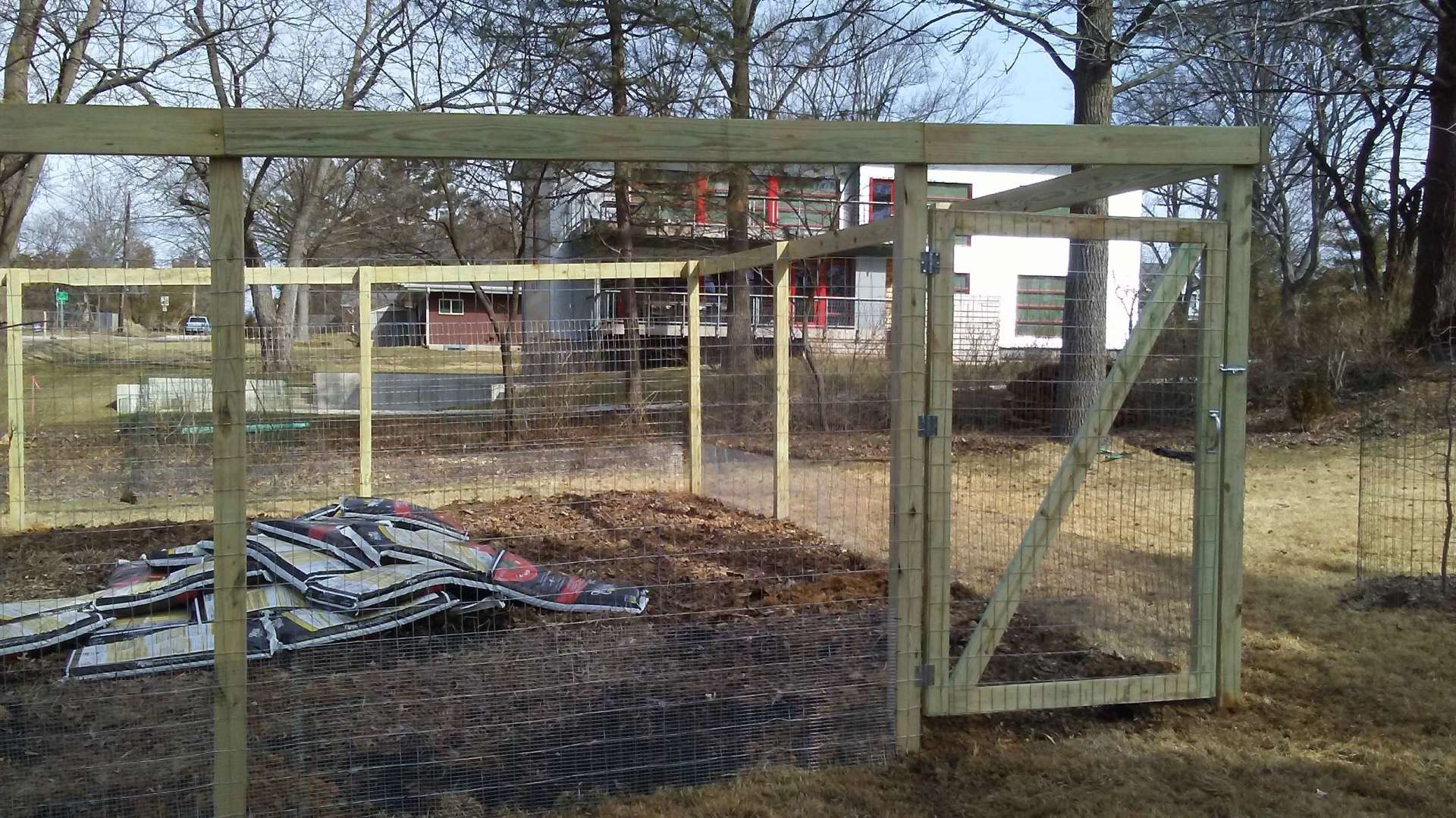 A wooden fence with a gate in the middle of it