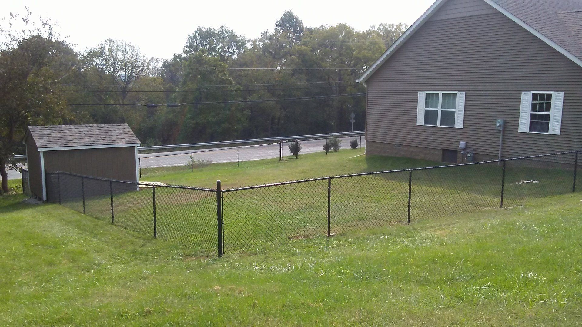 A house with a chain link fence in front of it