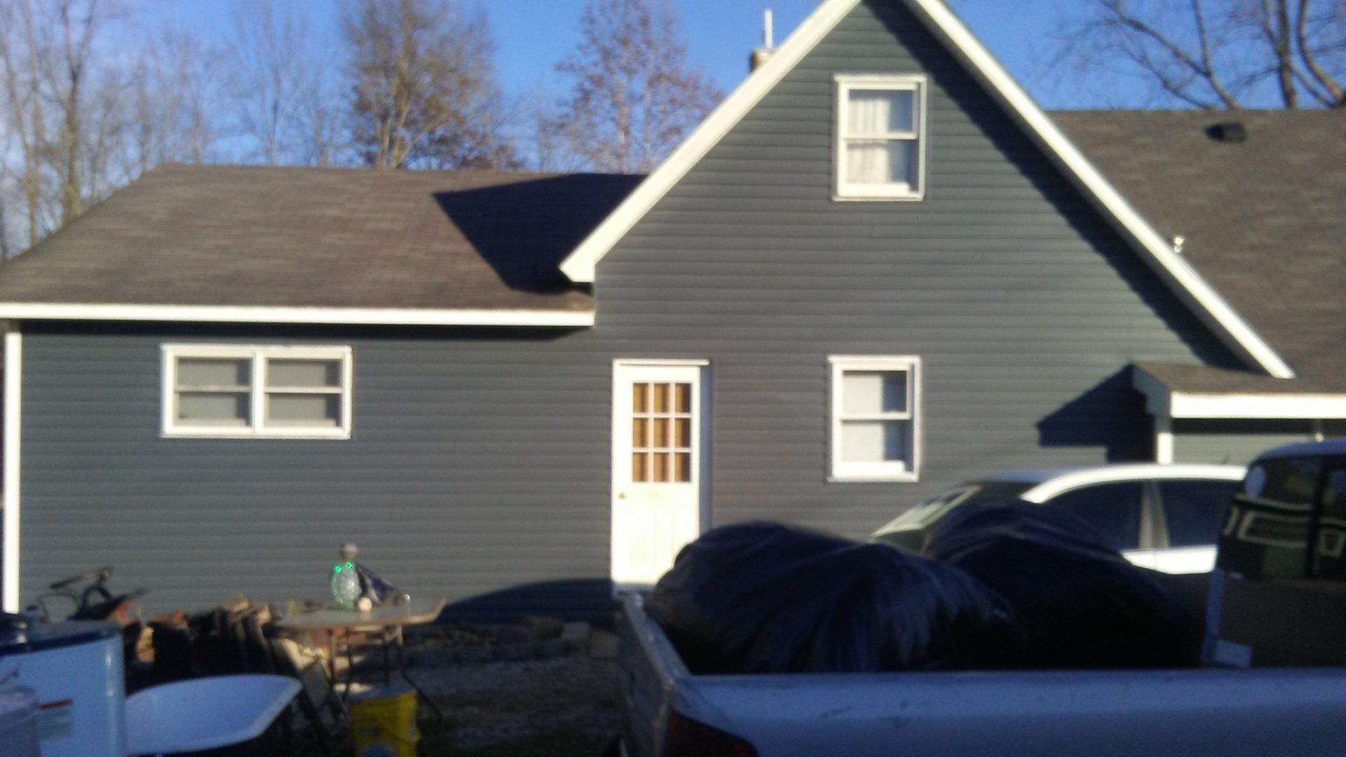 A truck is parked in front of a large house