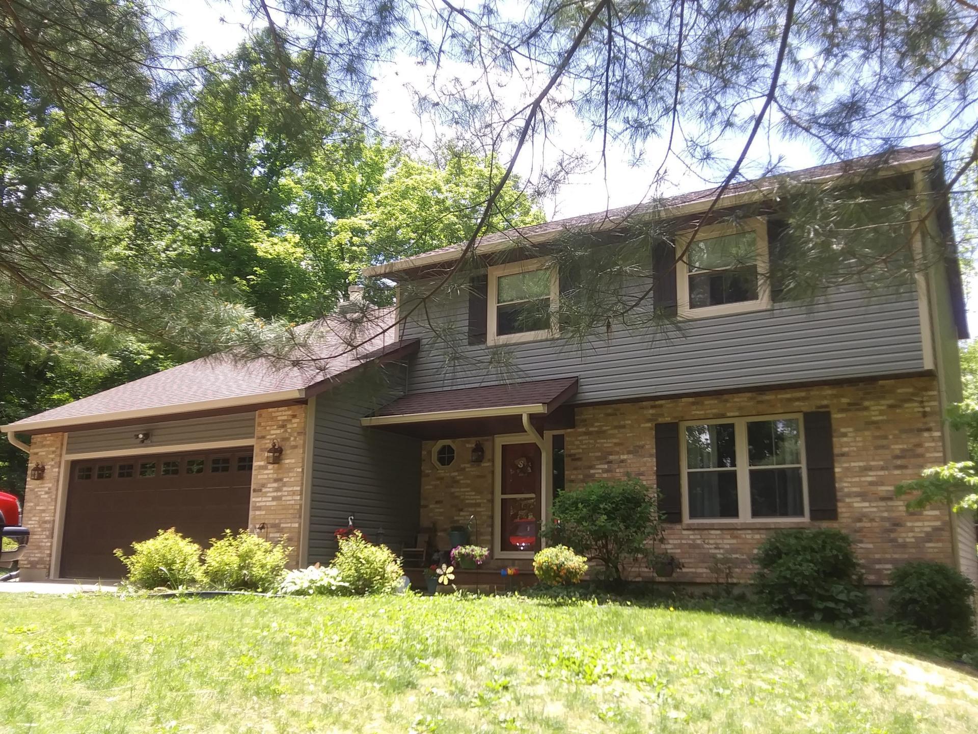 A large brick house with a garage and a lot of windows