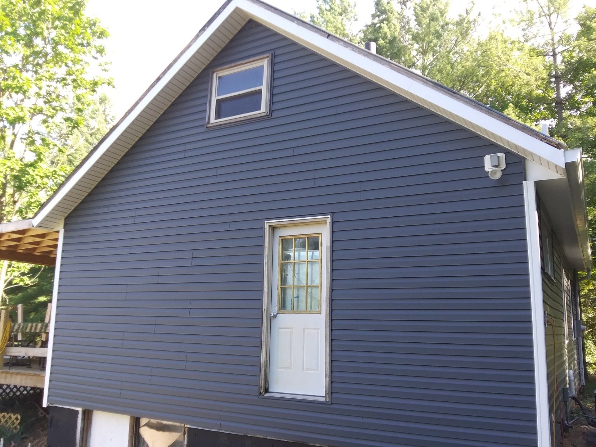 A black house with a white door and window