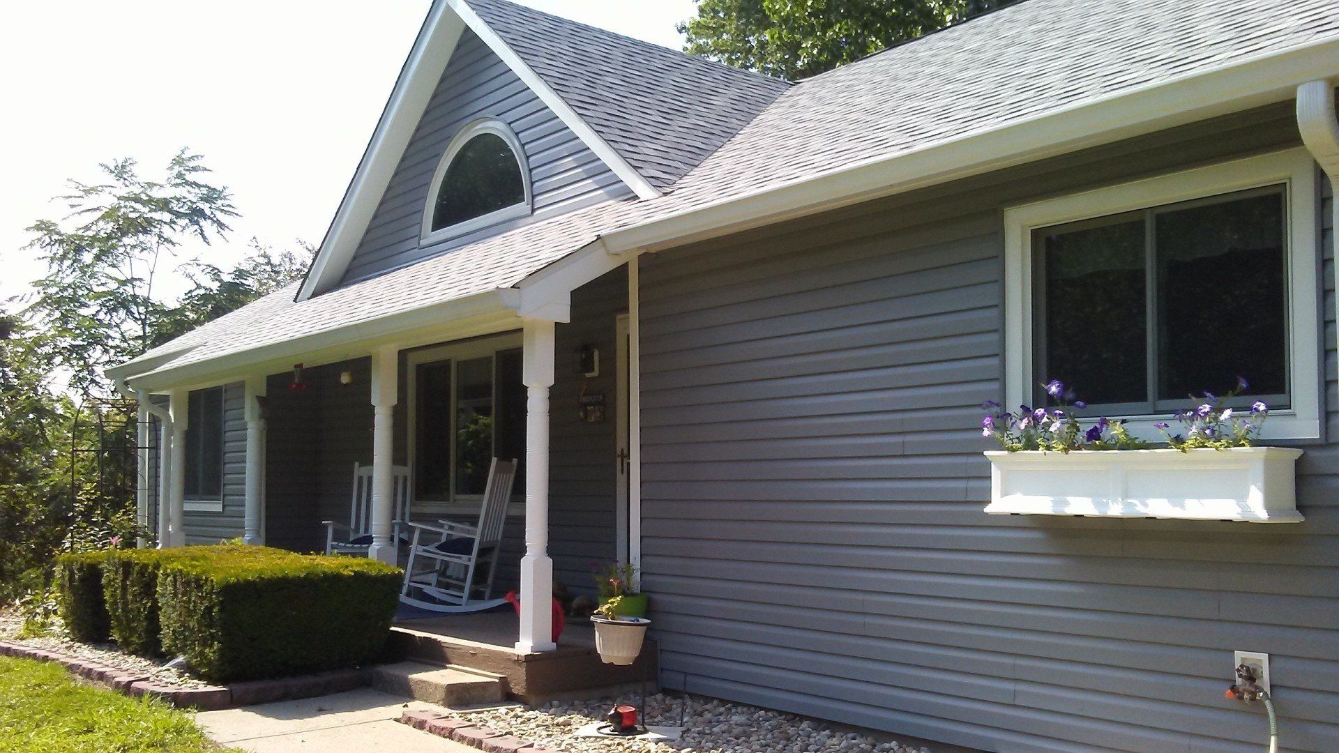 A house with a porch and a rocking chair on it