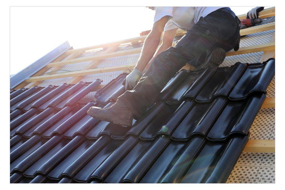 A man is working on the roof of a building