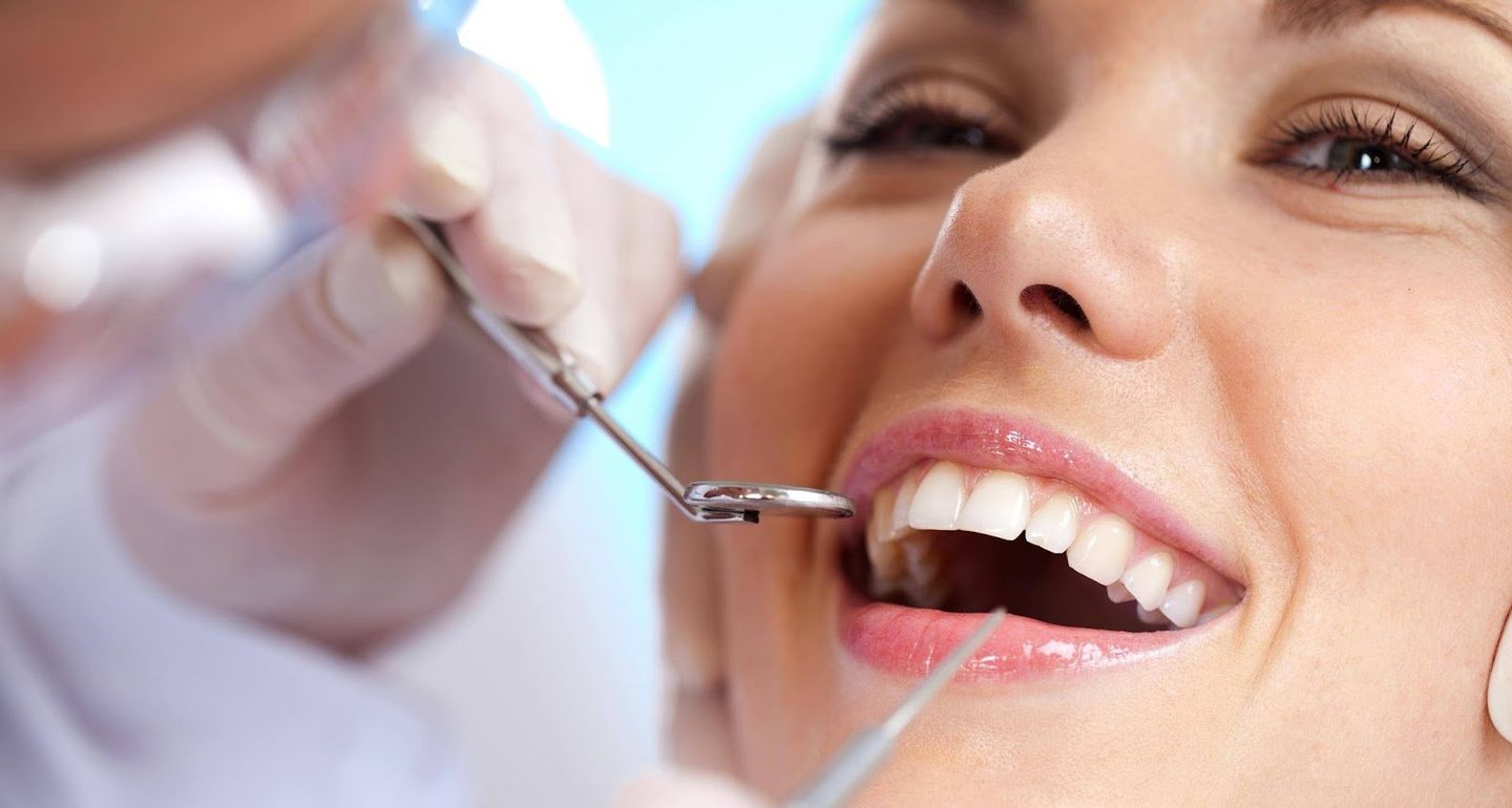 Dental Hygienist Inspecting Teeth