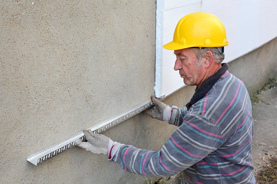 contractor measuring the wall