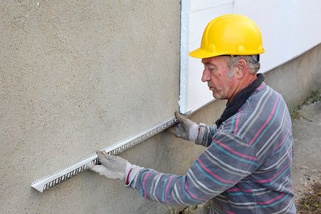 contractor measuring the wall