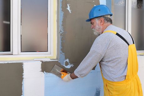 contractor repairing the wall