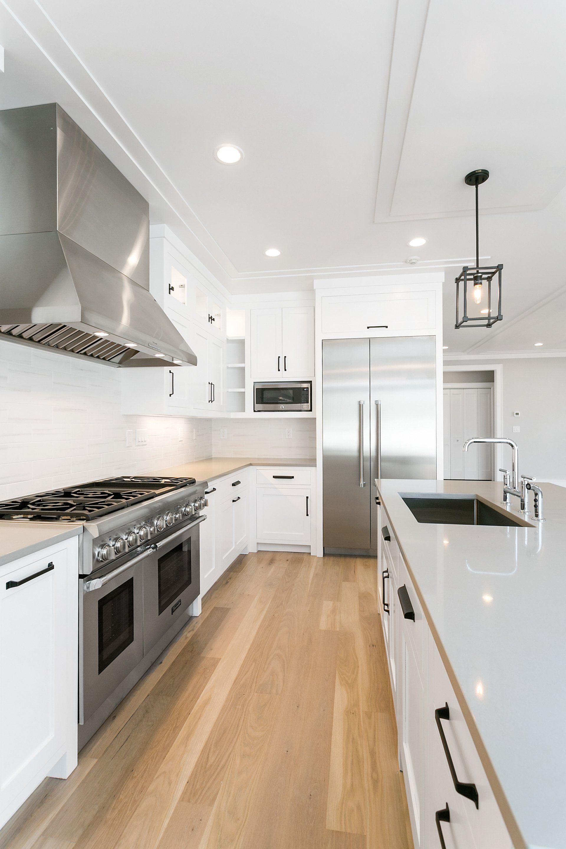 White Kitchen Cabinets & Gas Range with Silver