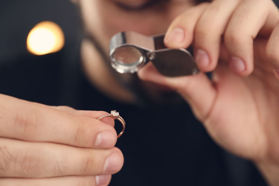 orafo con anello in mano