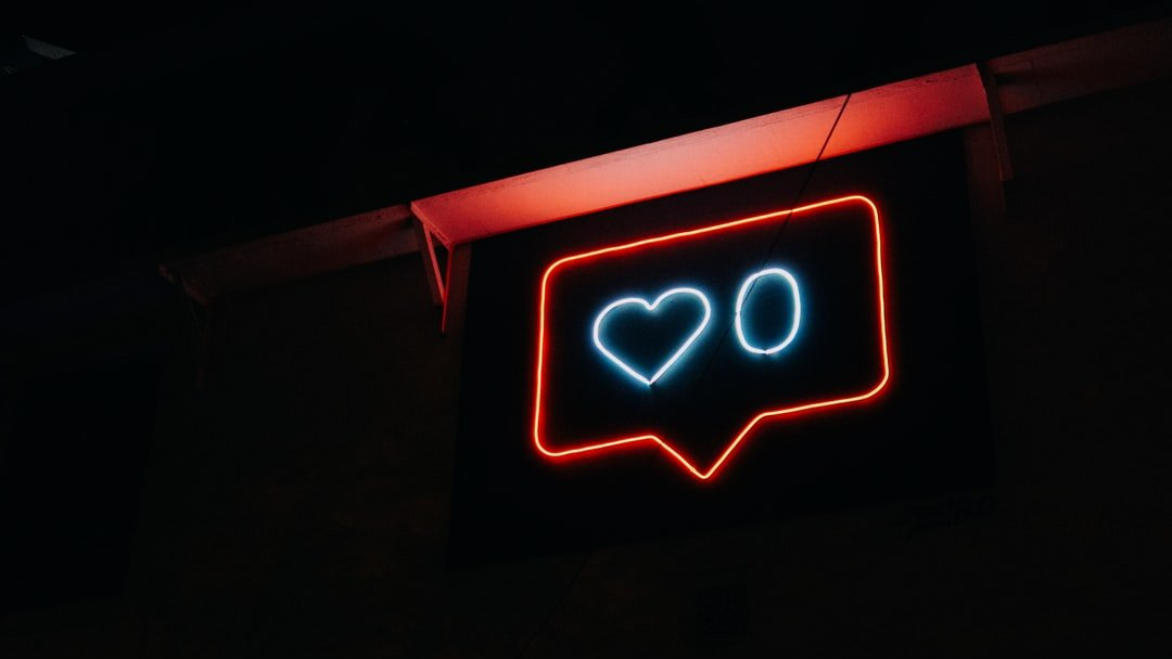 A neon sign with a heart in a speech bubble.