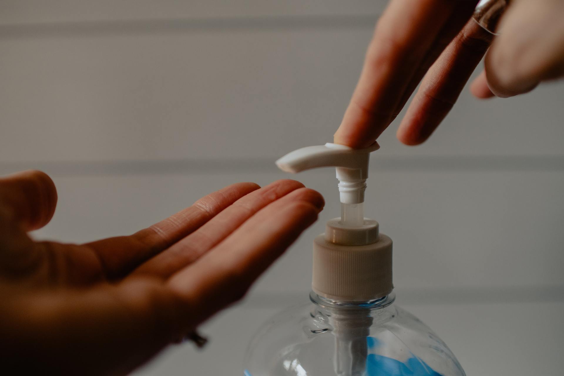 A person is applying hand sanitizer to another person 's hand.