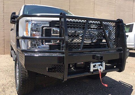 Winch — Truck Equipment in Albuquerque, NM White pickup truck with black front bumper guard and winch.