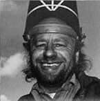 Smiling man with beard and welding helmet.