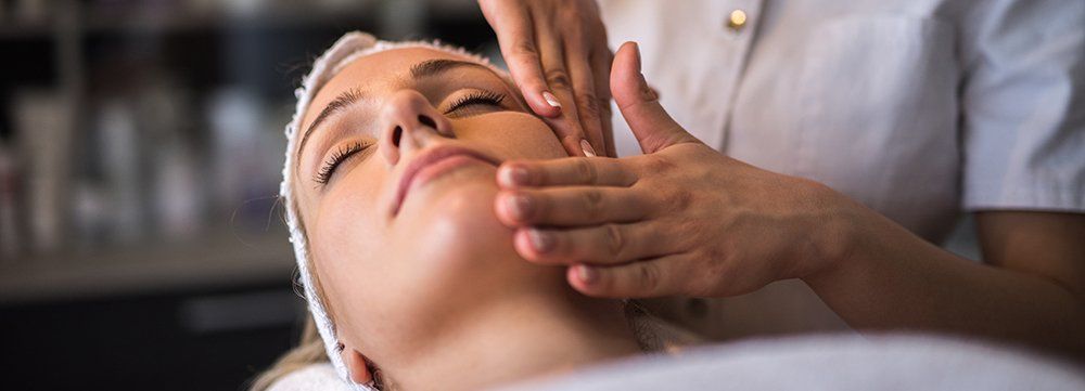 woman receiving facial at spa