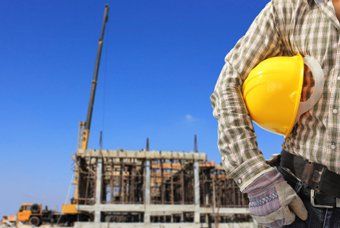 building behind a construction worker — Construction in Quincy, IL
