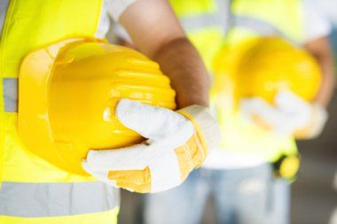 workers holding safety helmet — Construction in Quincy, IL workers holding safety helmet — Construction in Quincy, IL