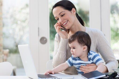 Mother Having a Phone Call With Her Son on Her Lap — Plumbing Services in Corpus Christi, TX
