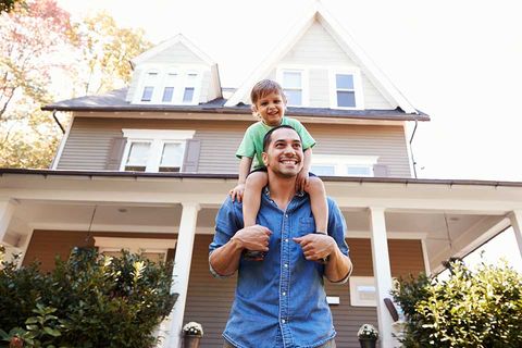 Father and Son Outside Their House — Financing in Buford, GA Father and Son Outside Their House — Financing in Buford, GA