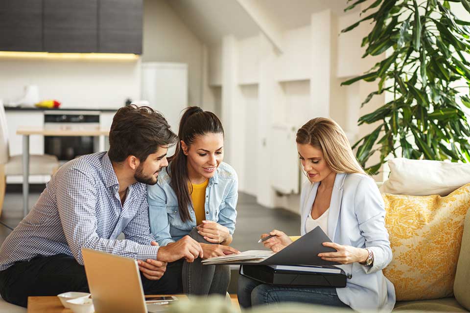 Real Estate Agent Offering Money Loans to Young Couple — Fixing Houses in Buford, GA