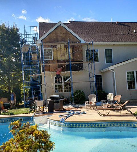 Premium Stucco Repair — Plastering the Wall with Spatula in Brick, NJ