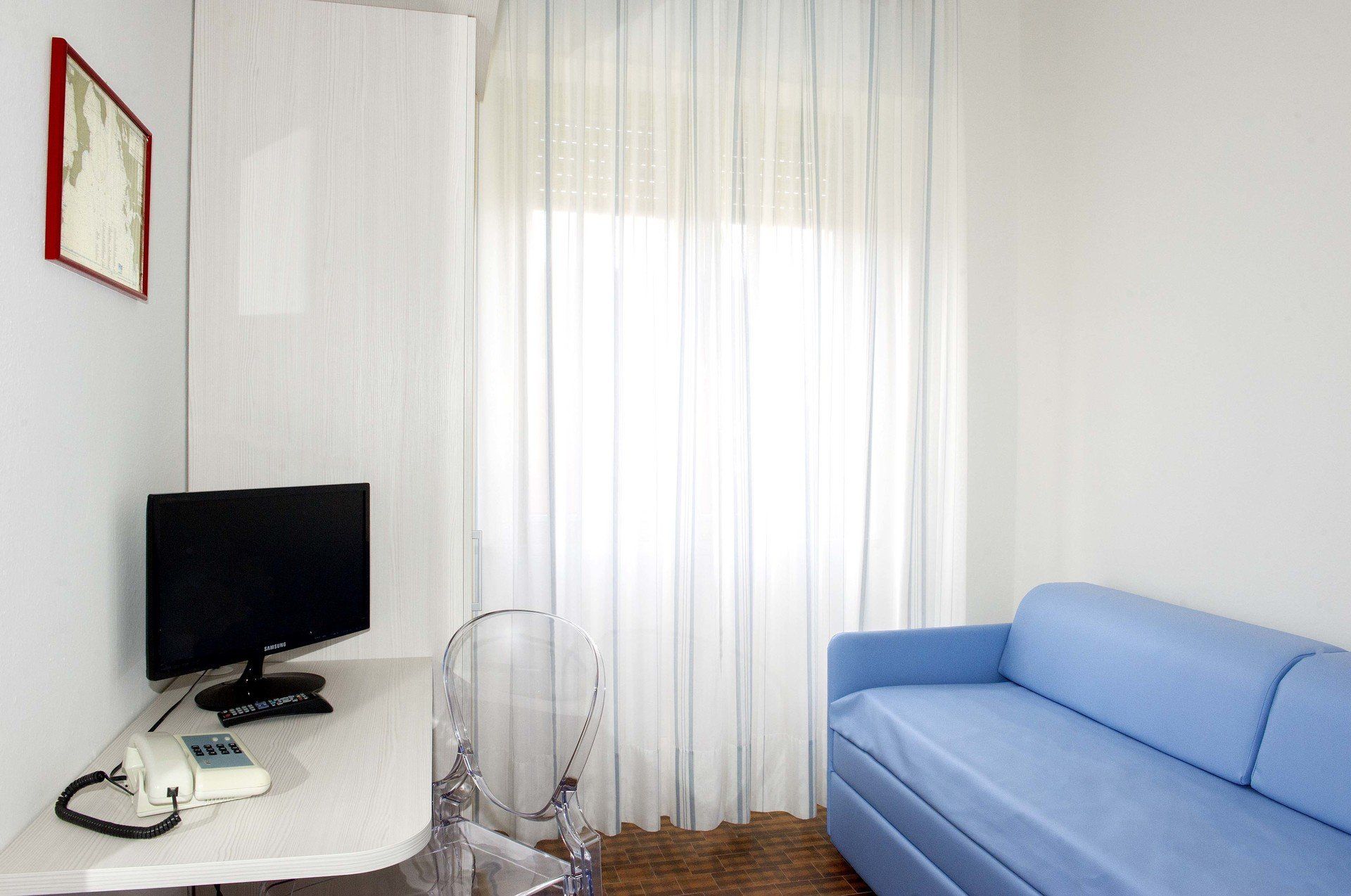 room with blue sofa and desk