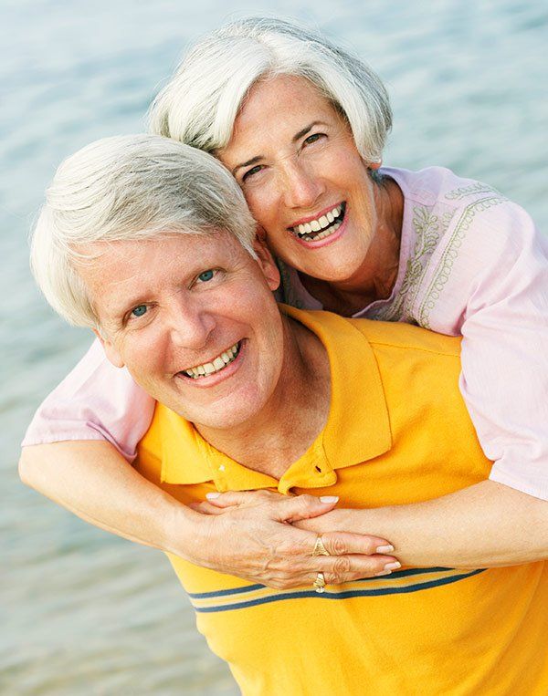 mandurah dental surgery root canal therapy Happy senior couple on the beach