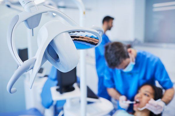 mandurah dental surgery dental fillings dentist looking with a mirror inside a womans mouth