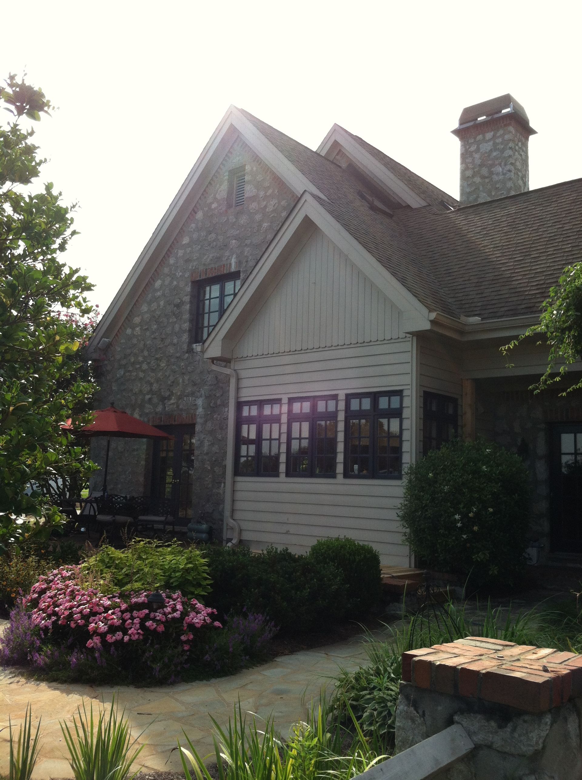 A large house with a lot of windows and a chimney
