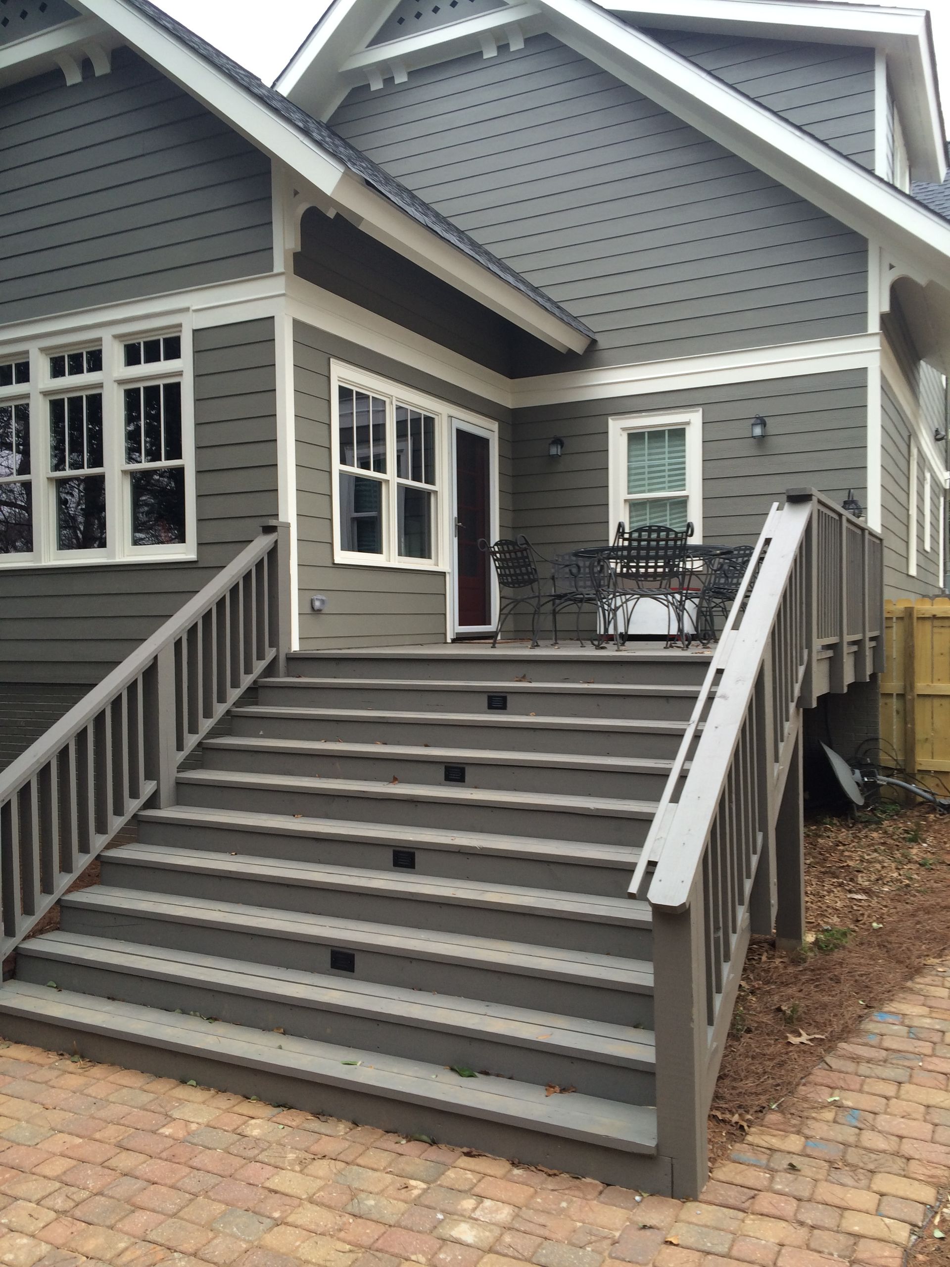 A house with a deck and stairs leading up to it