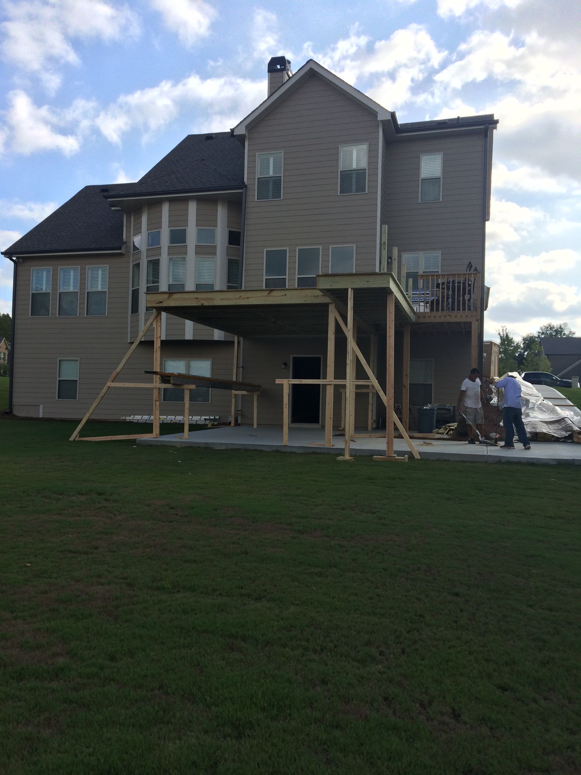 A large house with a large deck in front of it