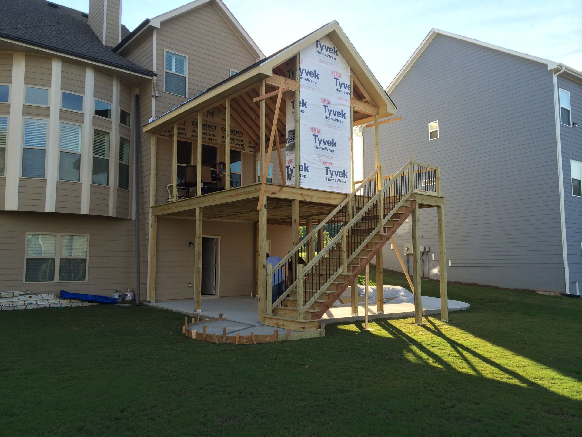 A house is being built with a deck and stairs.