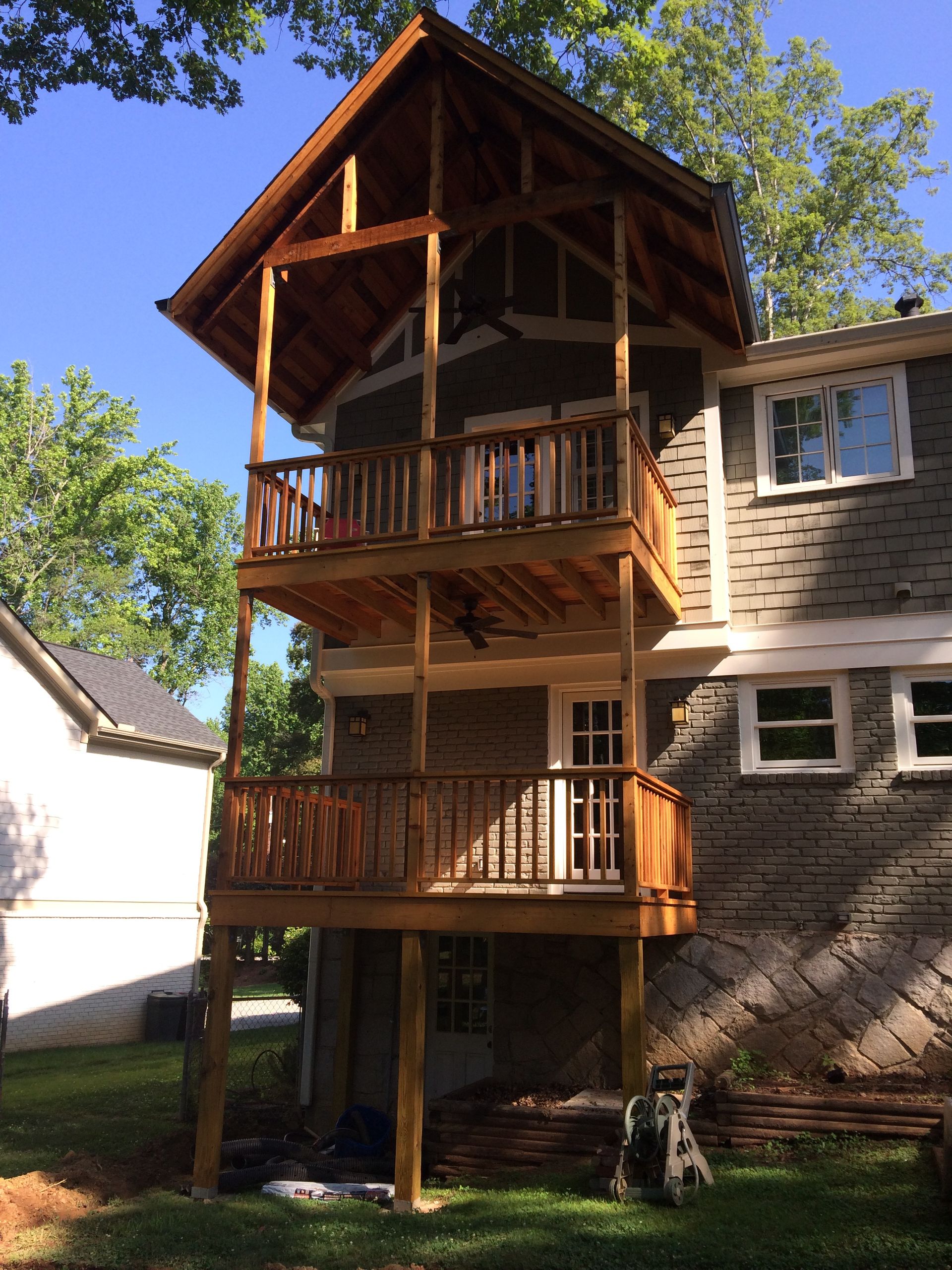 A house with a wooden deck on top of it