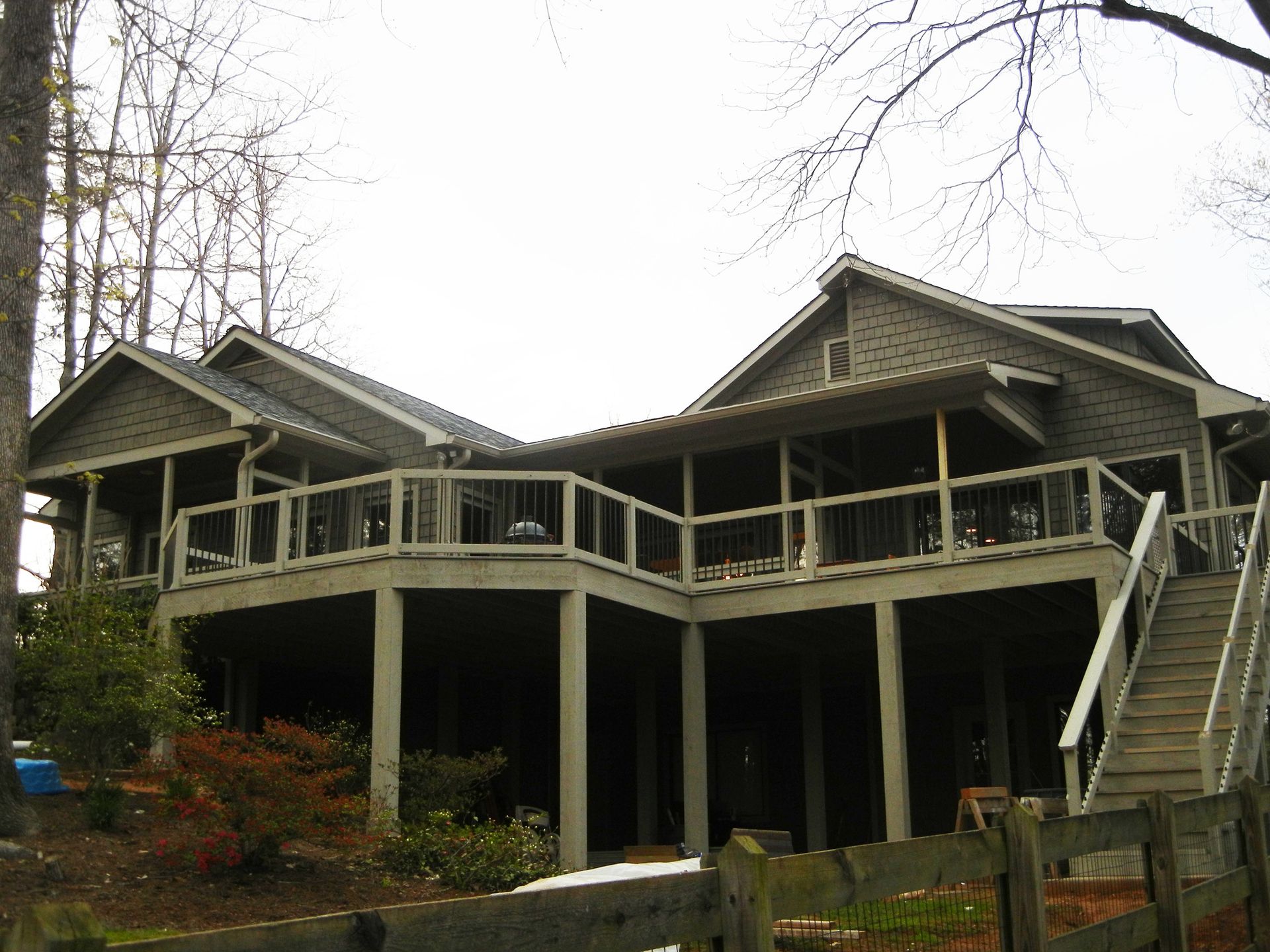 A large house with a large deck and stairs