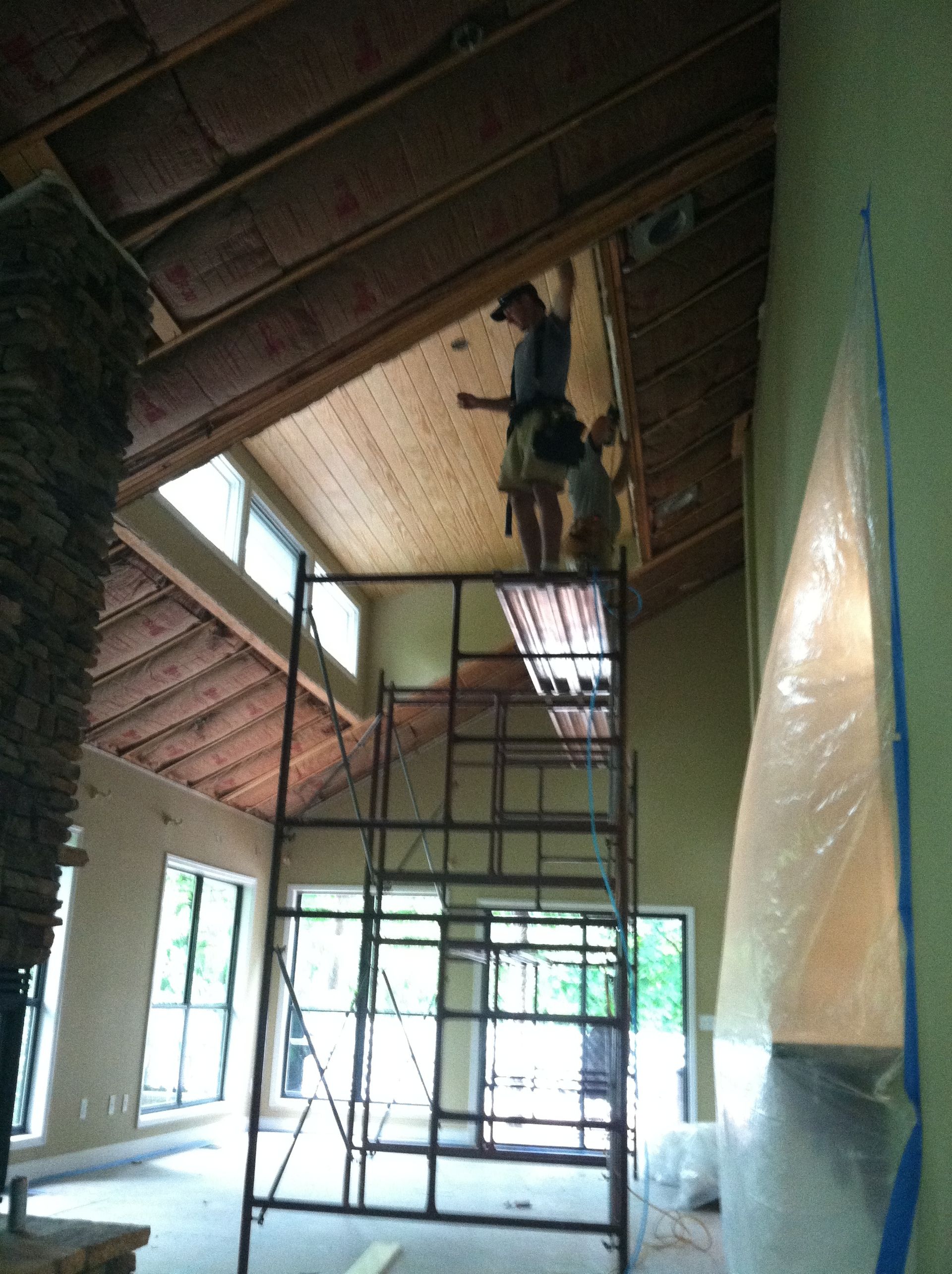 A man standing on a scaffolding in a room