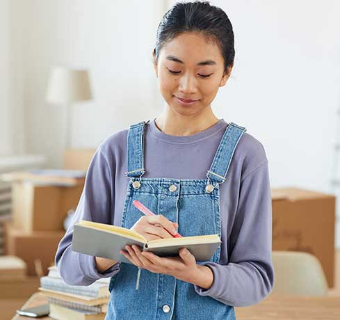 Woman Writing the list of items for moving