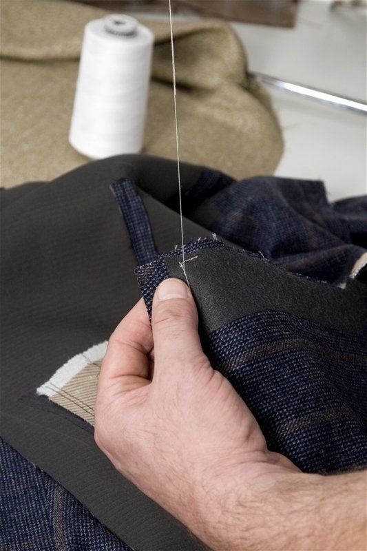 A person is sewing a piece of fabric on a sewing machine