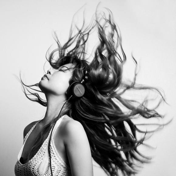 Woman with head back wearing headphones with long flowing hair - Revive Hairdressing Hairdressers - The Palms, Shirley, Christchurch