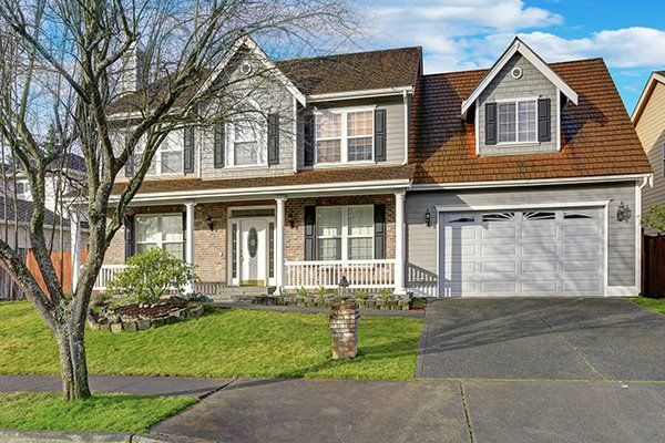 House Exterior with Garage Doors — Hasbrouck Heights, NJ — Reiner Overhead Door
