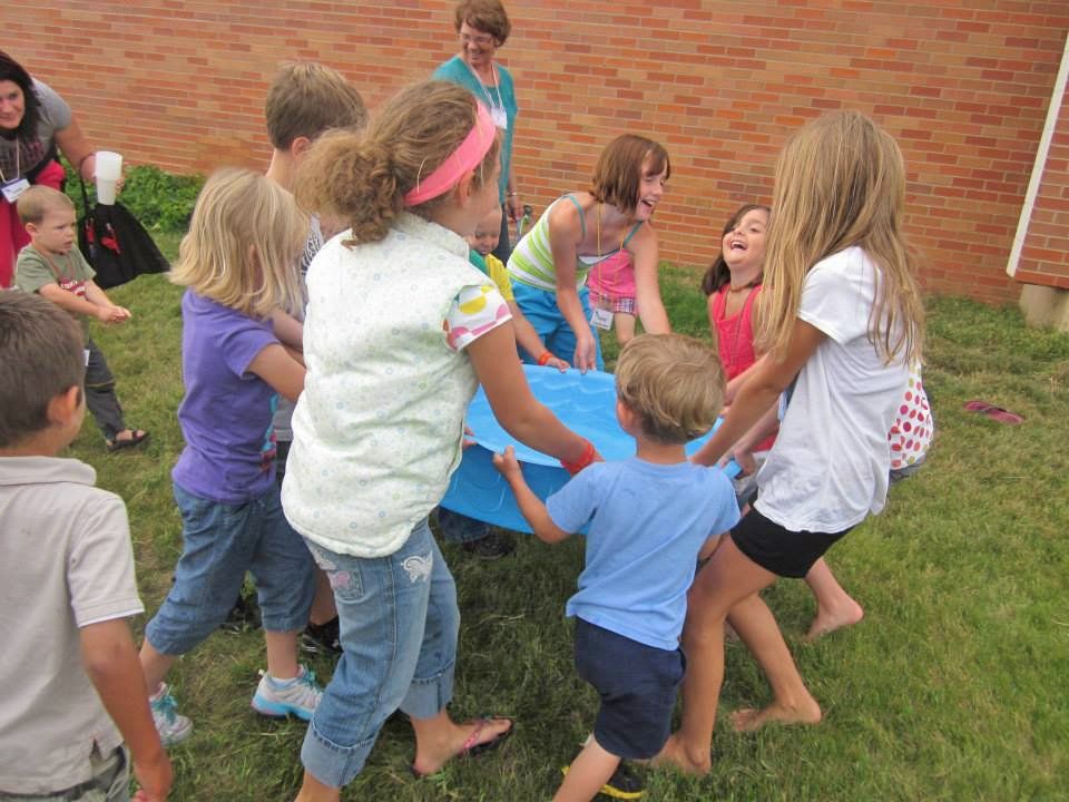 kids playing outside with a pool
